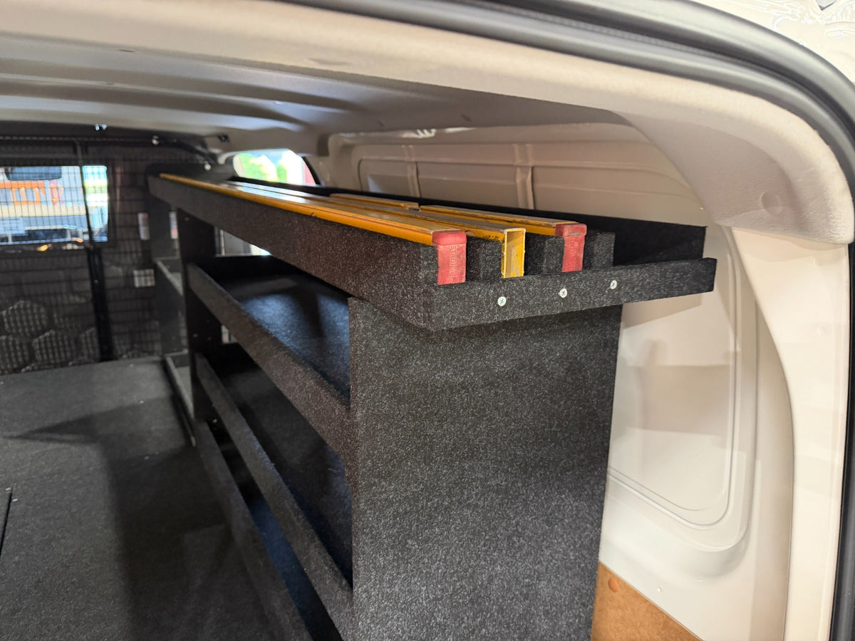 Drawer-top shelving with levels and straightedges stored lengthways on the dedicated top shelf