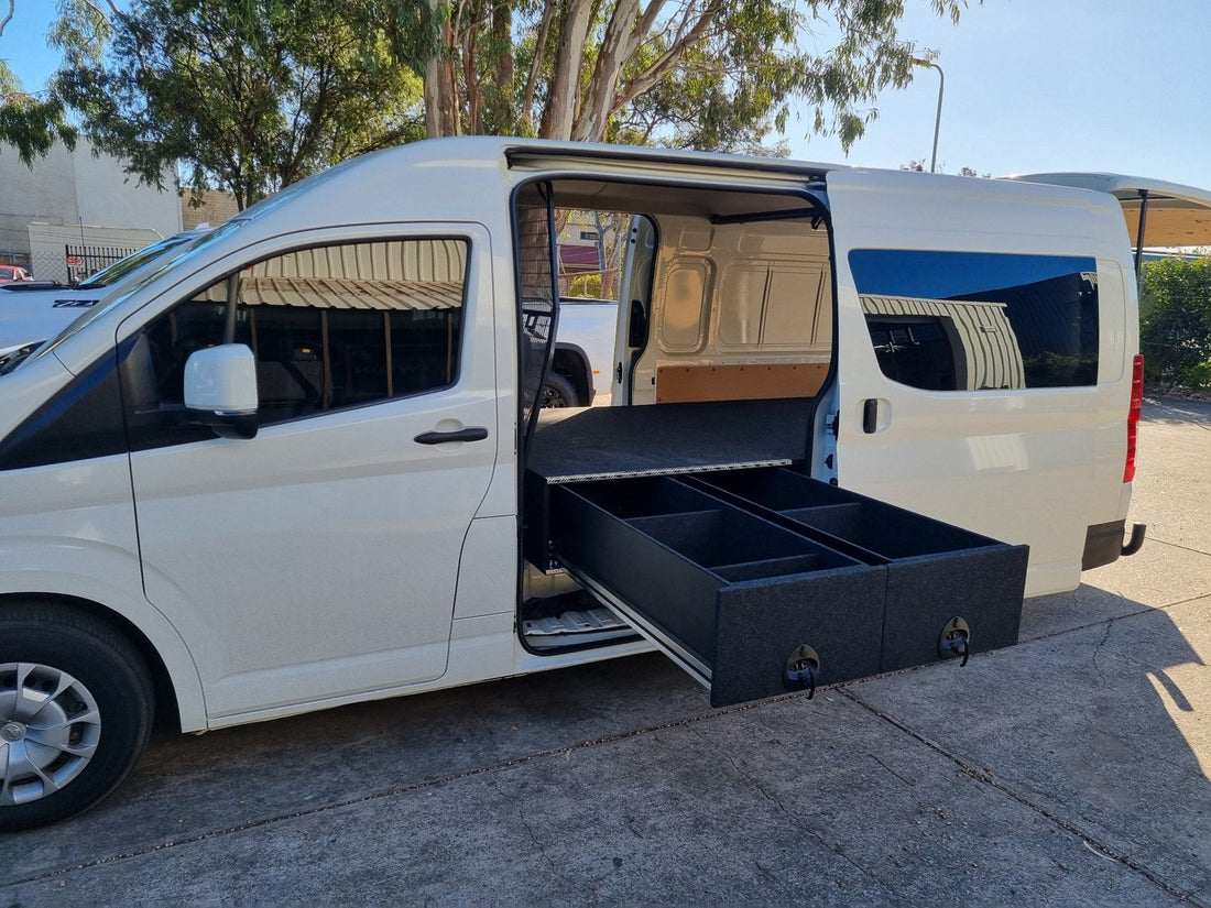 Toyota HiAce with two side-access drawers extended beneath a carpeted loading deck
