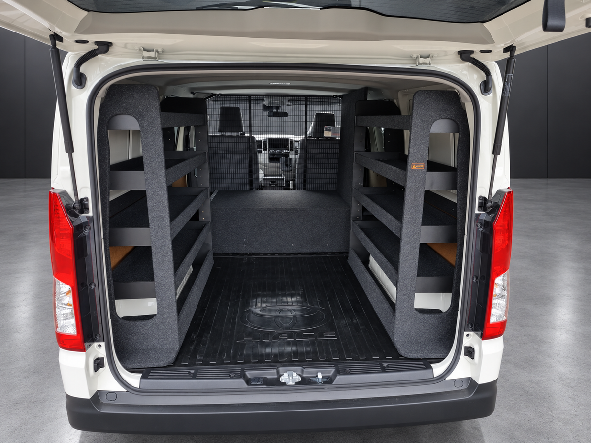 Two full-height shelving bays fitted over the rear wheel arches of a Toyota HiAce