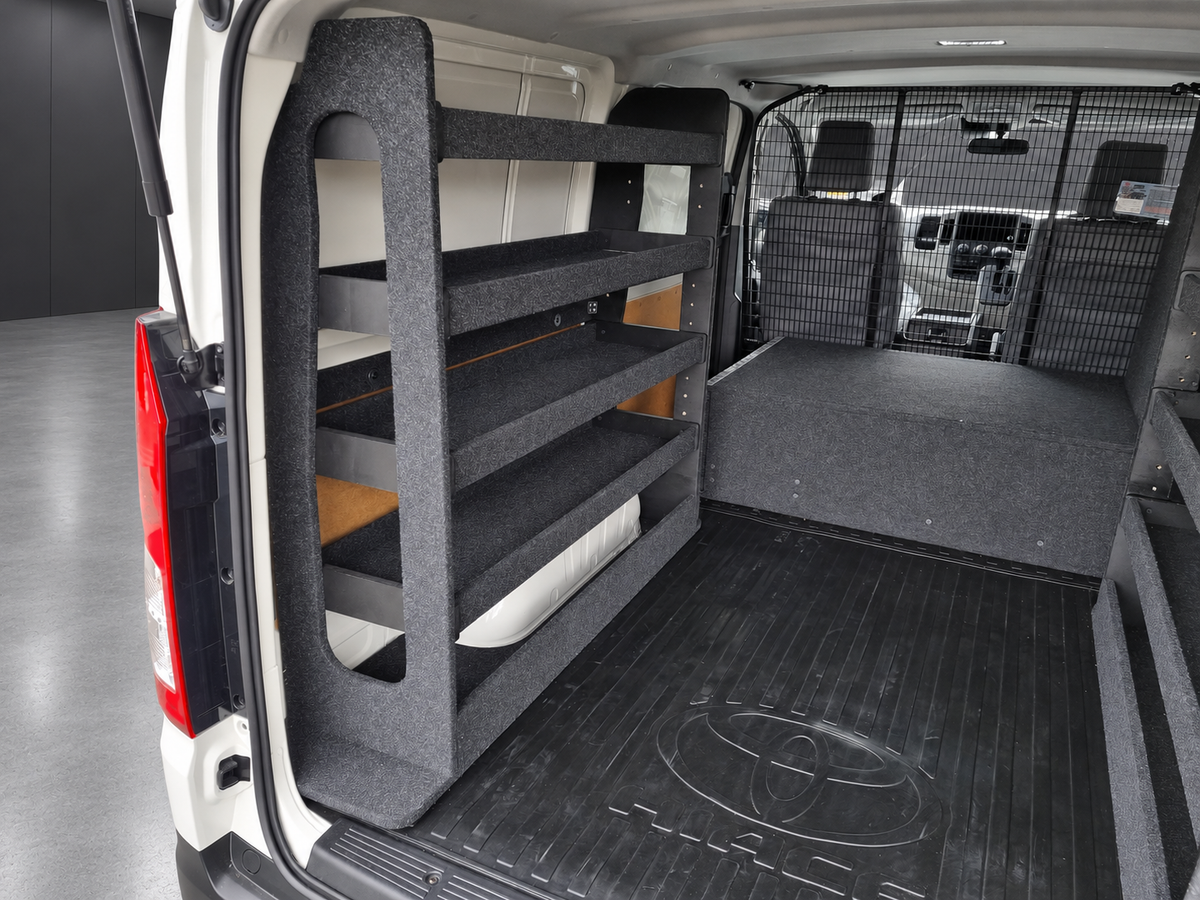 Close view of a full-height shelving bay built around a Toyota HiAce wheel arch