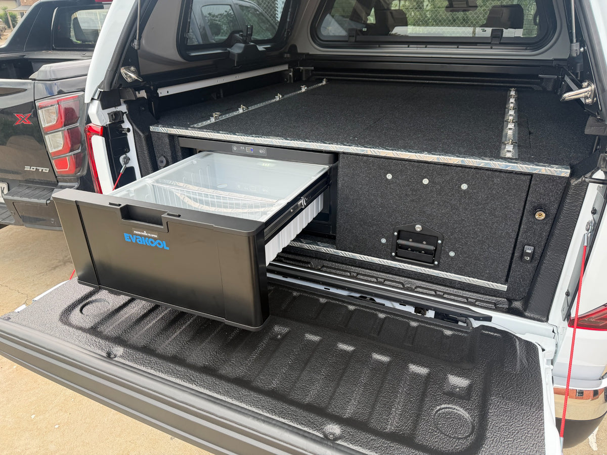 EvaKool 40 litre drawer fridge open in a VW Amarok beside the Lawson storage drawer