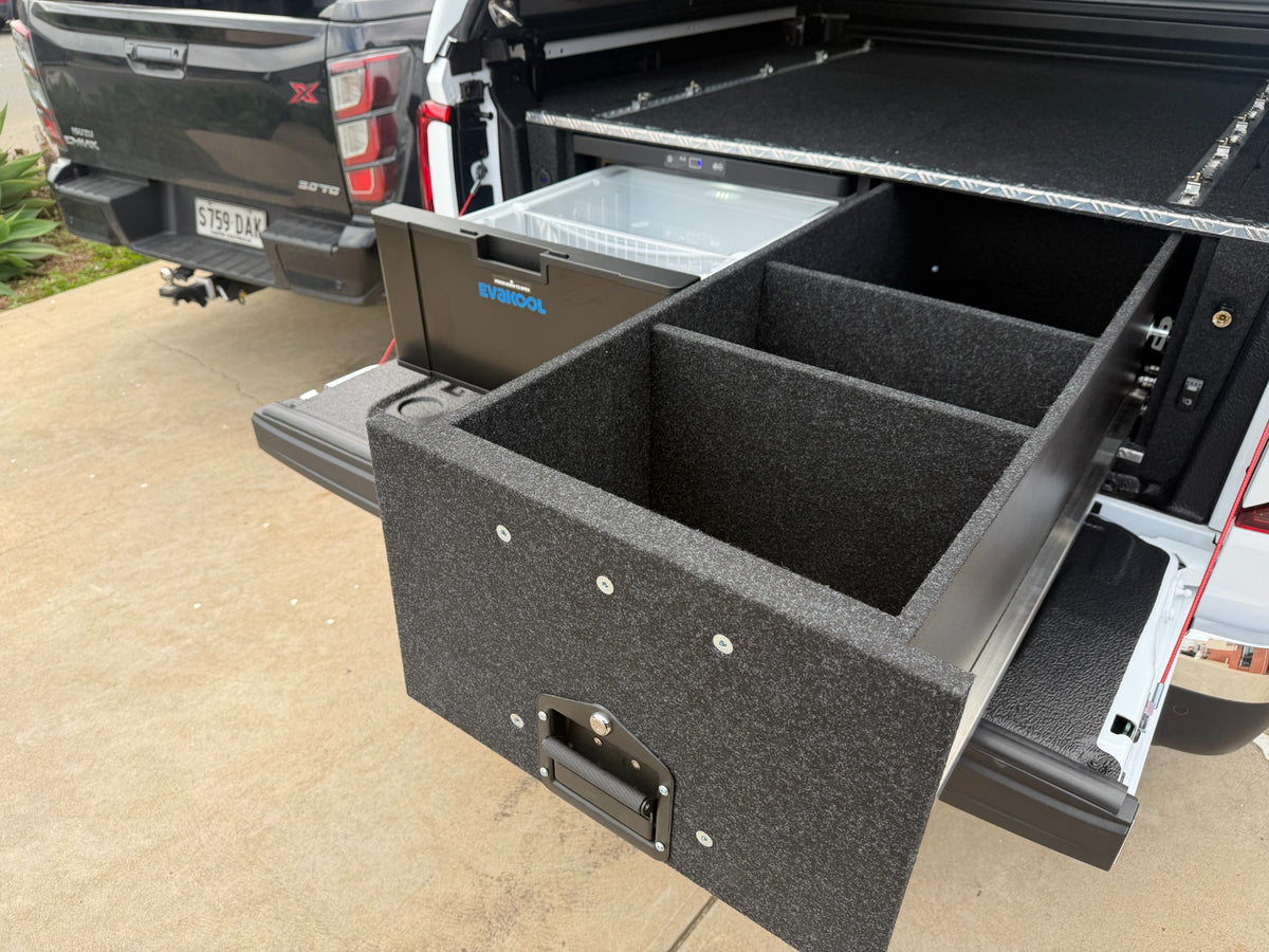 Angled view of the VW Amarok drawer fridge system with the storage drawer and fridge open