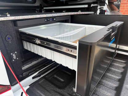 Close-up of the EvaKool 40 litre drawer fridge basket and side wing outlets in a VW Amarok
