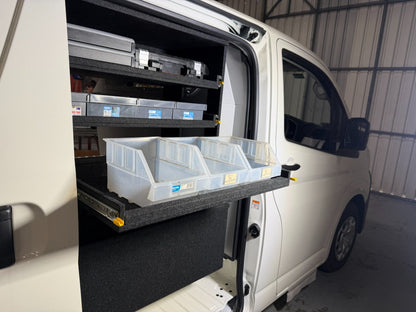 Access Side Door Shelving with storage bins on an extended shelf and tool cases in the shelving bay