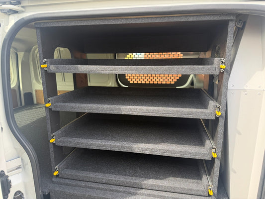 Front view of the Access Side Door Shelving bay in a Toyota HiAce showing individual sliding shelf modules