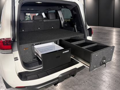 LandCruiser 300 Kings 30 litre fridge and matching raised drawer open, showing two carpeted dividers; wagon installation example, ute layout differs